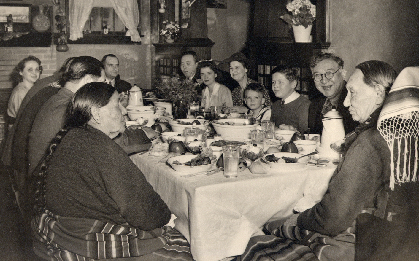 Photo Caption: Chief Fred Lookout at the head of the dinner table with his wife Julia Lookout to his left, n.d. ONM Collection P01-1261.